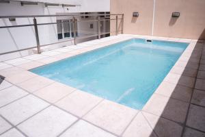 a swimming pool on top of a building at Luxor Hotel & Spa in Salta