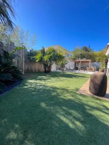 a yard with green grass and a fence at Villa Mimaël in Saint-Aygulf +8 photos