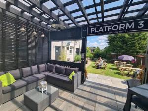 a patio with a couch and a sign that reads platinum at The Station Hotel in Worksop