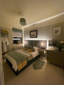 a bedroom with a large bed and a window at Cosy Room In Altrincham in Hale