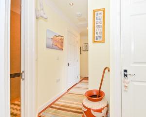 a hallway with a vase on the floor next to a door at Stunning Ocean Views, The Priory in Shanklin