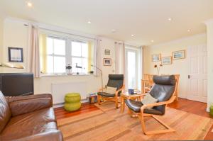 a living room with a couch and two chairs at Stunning Ocean Views, The Priory in Shanklin