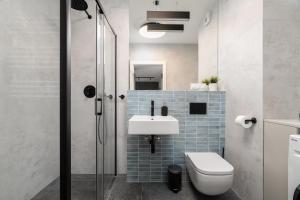 a bathroom with a sink and a toilet and a shower at Apartament przy Koscielnej in Poznań +27 photos