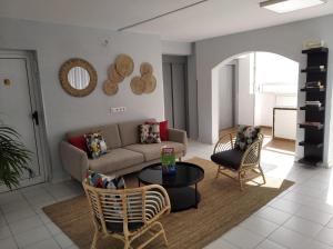 a living room with a couch and a table at Apartamentos Babalu in Puerto Rico de Gran Canaria +10 photos