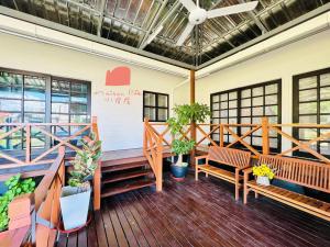 a deck with benches and plants in a building at Maison Life 小居屋 Holiday Home Kota Kinabalu in Kota Kinabalu