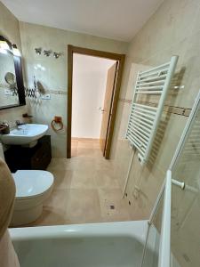 a bathroom with a tub and a toilet and a sink at Apartamento Algaida REF.004 in Oropesa del Mar +26 photos