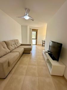 a living room with a couch and a flat screen tv at Apartamento Algaida REF.004 in Oropesa del Mar