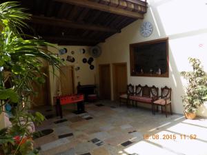 a living room with chairs and a tv on the wall at Casarao dos Reis in Caravela