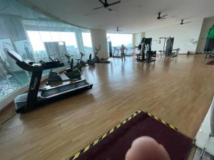 a gym with treadmills and a treadmill in a building at Charming Hideaway Room With Private Bathroom Near Bukit Jalil Stadium, Pavillion Bukit Jalil, APU in Kuala Lumpur