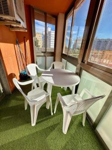 a balcony with a table and chairs and windows at Apartamento Algaida REF.004 in Oropesa del Mar
