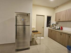 a kitchen with a refrigerator and a table in it at Charming Hideaway Room With Private Bathroom Near Bukit Jalil Stadium, Pavillion Bukit Jalil, APU in Kuala Lumpur
