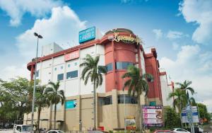 a large building with palm trees in front of it at Charming Hideaway Room With Private Bathroom Near Bukit Jalil Stadium, Pavillion Bukit Jalil, APU in Kuala Lumpur