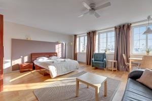 a bedroom with a bed and a living room at Dom & House - Apartments Old Town Targ Rybny in Gdańsk