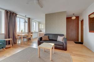 a living room with a couch and a table at Dom & House - Apartments Old Town Targ Rybny in Gdańsk