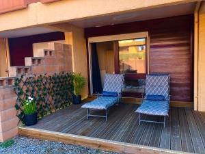 dos sillas sentadas en una terraza en una casa en Golf ground floor 2 bedrooms Apartment Saint Cyprien, en Saint-Cyprien