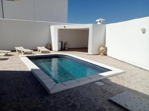 a swimming pool in the middle of a building at Villa phare 2 in Midoun