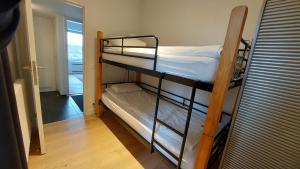 two bunk beds in a room with a hallway at Astrid - apartments in Mechelen