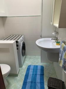 bagno con lavatrice e lavandino di SPELU - Appartamento con terrazza fronte mare a Lido Marini