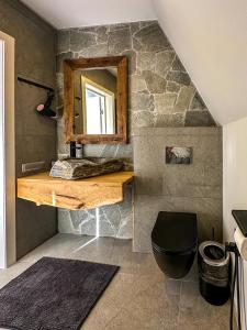 bagno con bancone in legno e specchio di Ultra house a Ilʼtsya Gurny