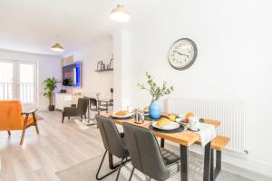 a dining room and living room with a table and chairs at Host & Stay - Davies Close in Market Harborough
