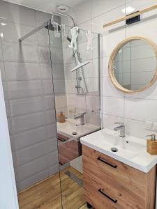 a bathroom with two sinks and a mirror at Siedem mórz in Gąski