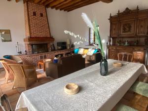 a living room with a table with a vase of flowers on it at Le Domaine de Toussacq in Villenauxe-la-Petite