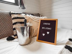 a chalkboard sign on a bed with a welcome sign at 1 Bed in Corwen 80321 in Gwyddelwern