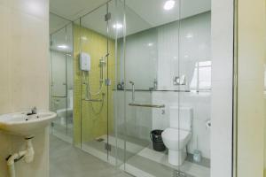 a bathroom with a shower and a toilet and a sink at SUMMER SUITES APARTMENT CASETTA HOMESTAY 2 at Kota Samarahan Kuching in Kuching +15 photos