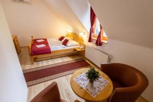 a small room with a bed and a table at Hotel Koliba in Senec +52 photos