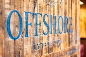 リザム・セント・アンズにあるOffshore - The Inn Collection Groupの木壁の看板