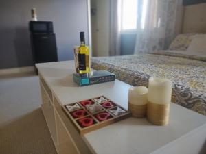 einen Tisch mit einer Flasche Wein und Kerzen auf dem Bett in der Unterkunft Executive Master Suite With Soaker Tub - Very Close to the Falls and Marineland in Niagara Falls