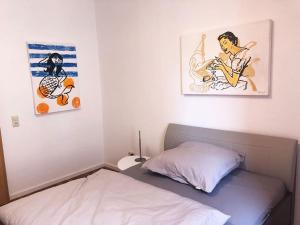a bedroom with a bed and two pictures on the wall at Apartment in Innenstadt Bielefeld in Bielefeld +6 photos