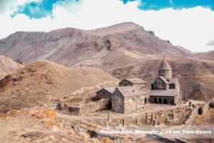 an old church in the middle of a mountain at Hotel Basen in Sisian