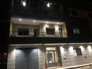 un edificio con puerta y balcón por la noche en Seaside Serenity Retreat 2BR - Exclusively for Families, en Ras El Ma