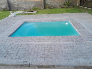 a swimming pool in the middle of a brick walkway at Golentle Home Stay in Maun