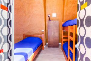 two bunk beds in a room with a door open at Hostal Cosmo Elqui in Rivadavia