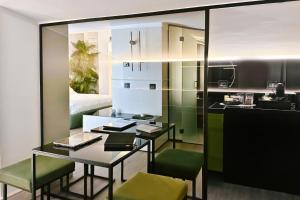 Amamare Luxury Room في جوليانوفا: مطبخ مع طاولة وكراسي خضراء في غرفة