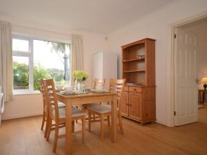 a kitchen with a table and chairs and a refrigerator at 2 Bed in Bude 53635 in Bude