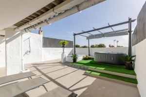 an outdoor patio with a pergola and grass at YourHouse Es Pla Cycling House in Maria de la Salut