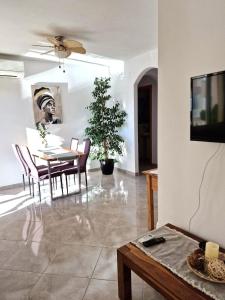 a living room with a table and chairs and a tv at Arenal in Jávea +45 photos