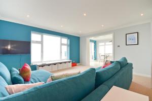 a blue living room with a large blue couch at Princes Esplanade in Cowes