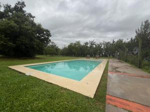 a swimming pool in the middle of a yard at Finca Las Acacias in Marcos Paz