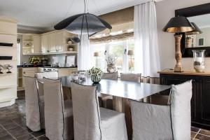 a kitchen and dining room with a table and chairs at Home-by-Sea in Westerland (Sylt)