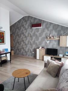 a living room with a couch and a table at Apartment Nika in Umag