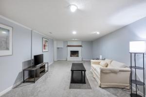 a living room with a couch and a tv at Sofia's Square Unit 2 in Omaha