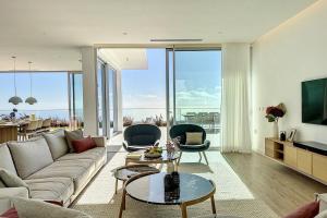 a living room with a couch and a table at Villa OceanAIR by LovelyStay in Prazeres