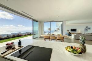 a kitchen and living room with a view of the ocean at Villa OceanAIR by LovelyStay in Prazeres