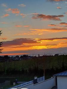 a view of the sunset from the roof of a house at Les Suites de Véronique, chez Véronique Olive in Saint-Pair-sur-Mer