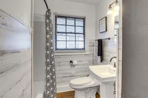 a white bathroom with a toilet and a sink at Residential Birmingham Home, 5 Mi to Downtown! in Birmingham +18 photos