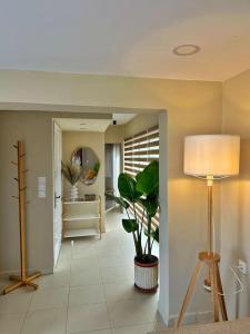 a hallway with a lamp and a plant in it at Filoxenia City Apartment in Zakynthos